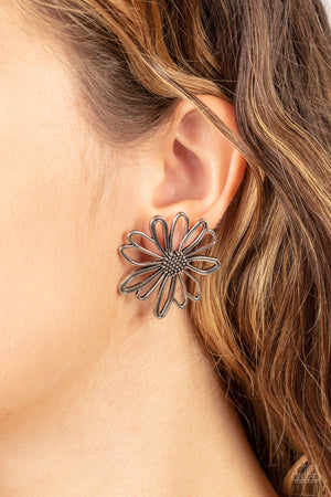 Airy silver petals bloom from a studded silver center, creating a rustic flower