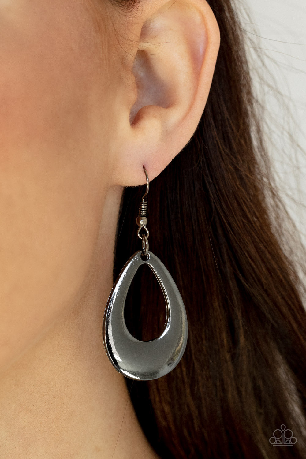 A thick gunmetal teardrop frame drips from the ear, creating an alluring lure. Earring attaches to a standard fishhook fitting.
