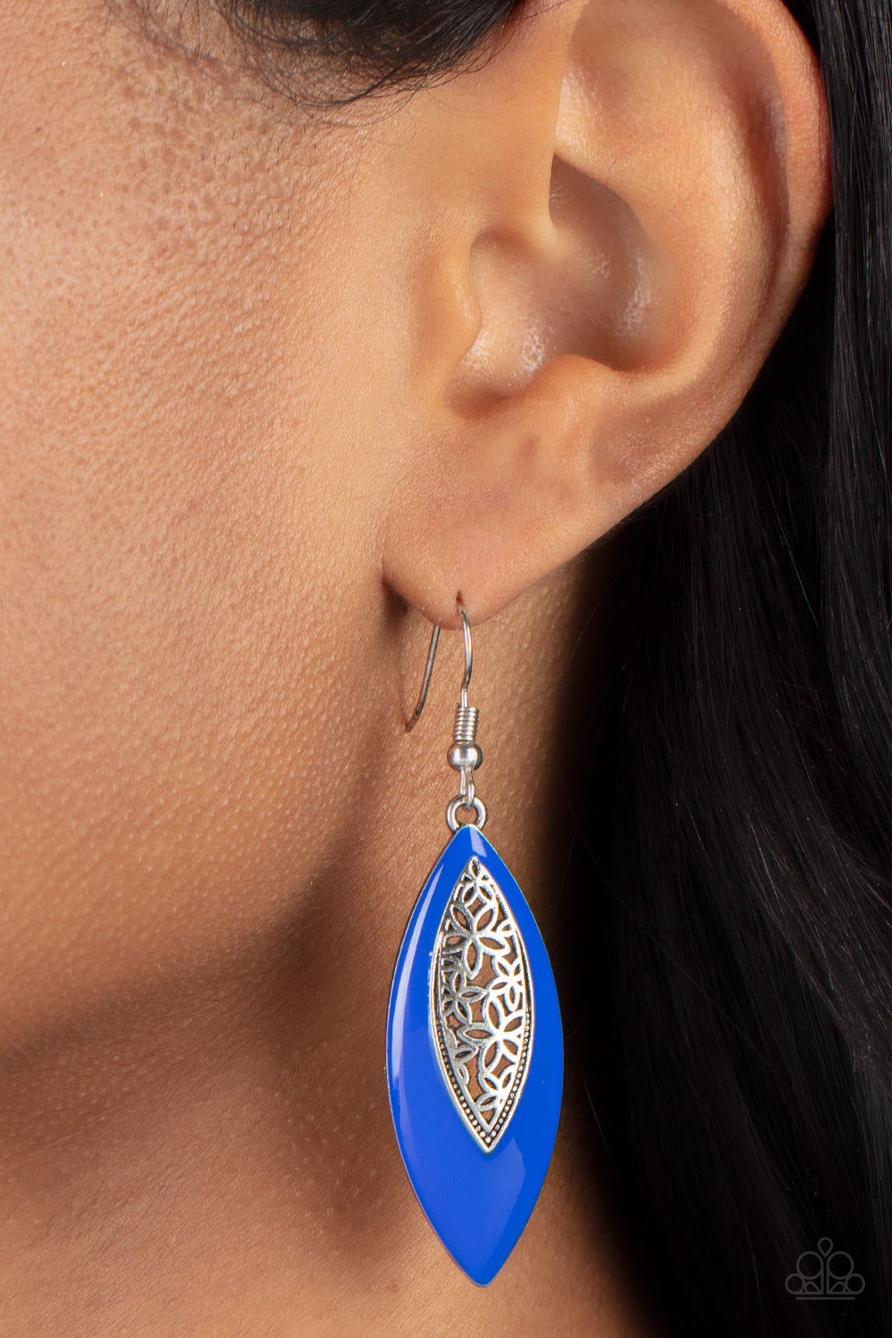 Asymmetrically bordered in a bright Mykonos Blue frame, airy silver filigree blooms along the center of a colorful lure 