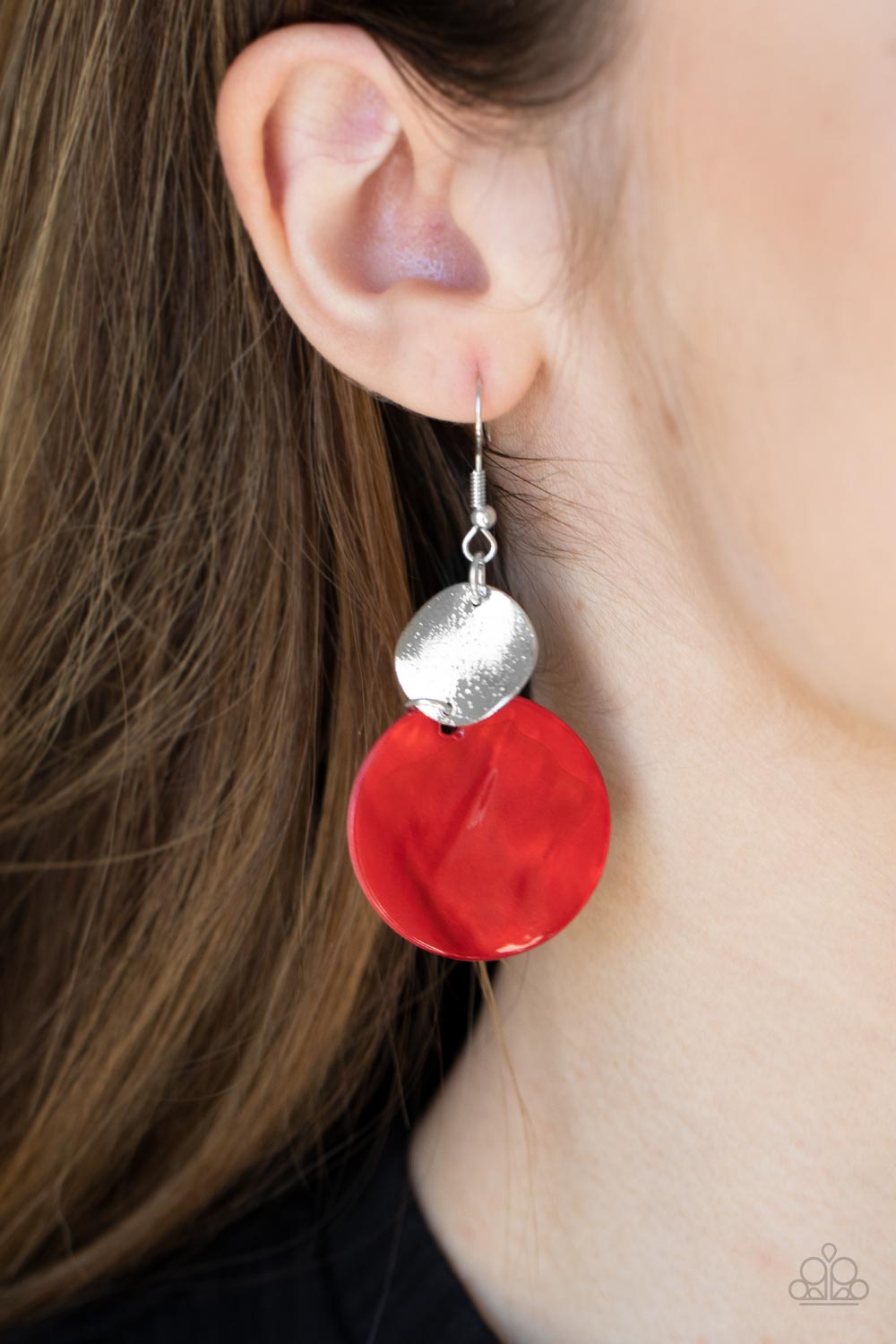 Red oversized shell-like disc is topped by a wavy sparkling silver disc
