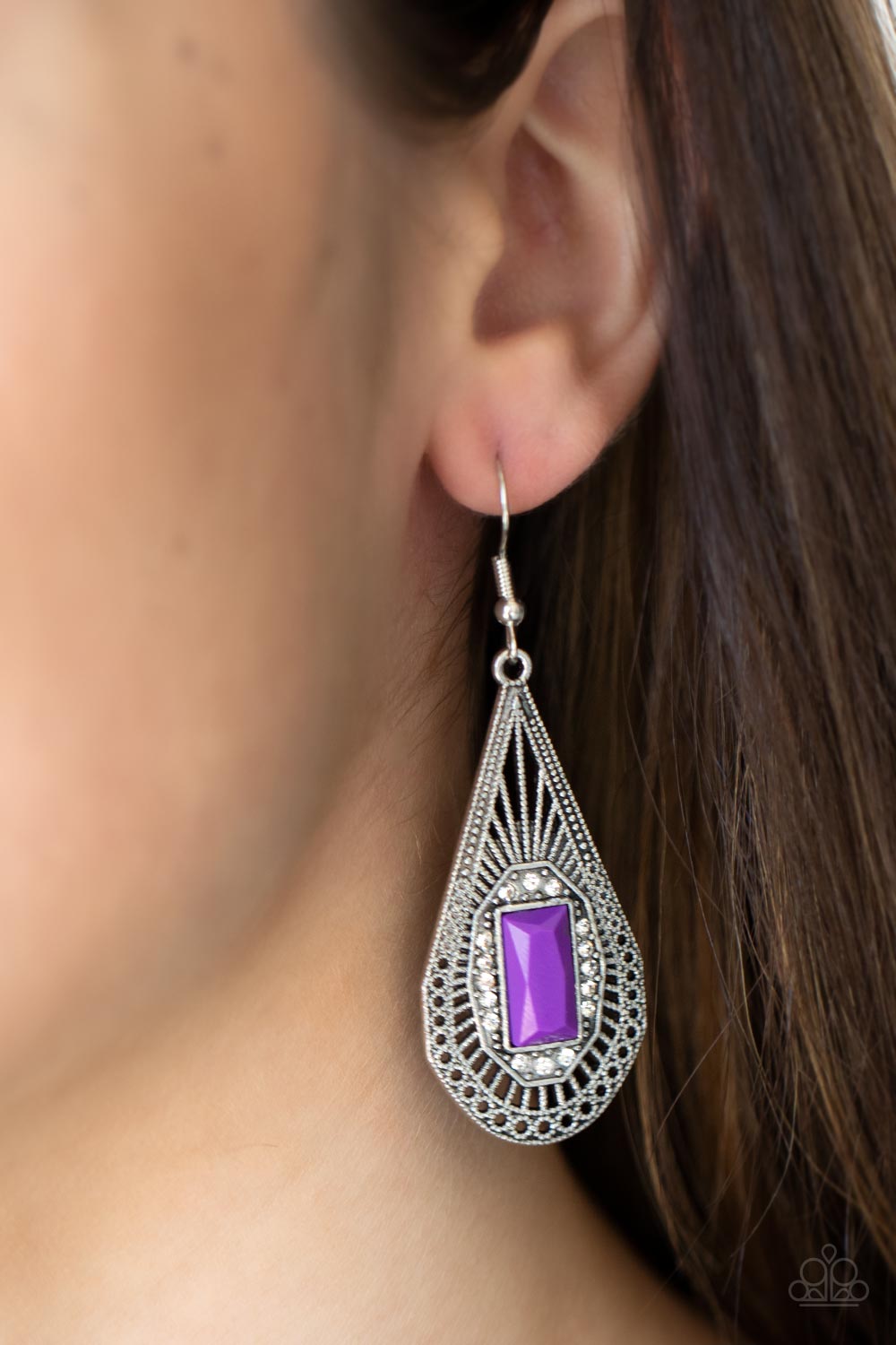 A bright purple baguette-cut bead, bordered with sparkling white rhinestones, sits center stage inside a teardrop frame.