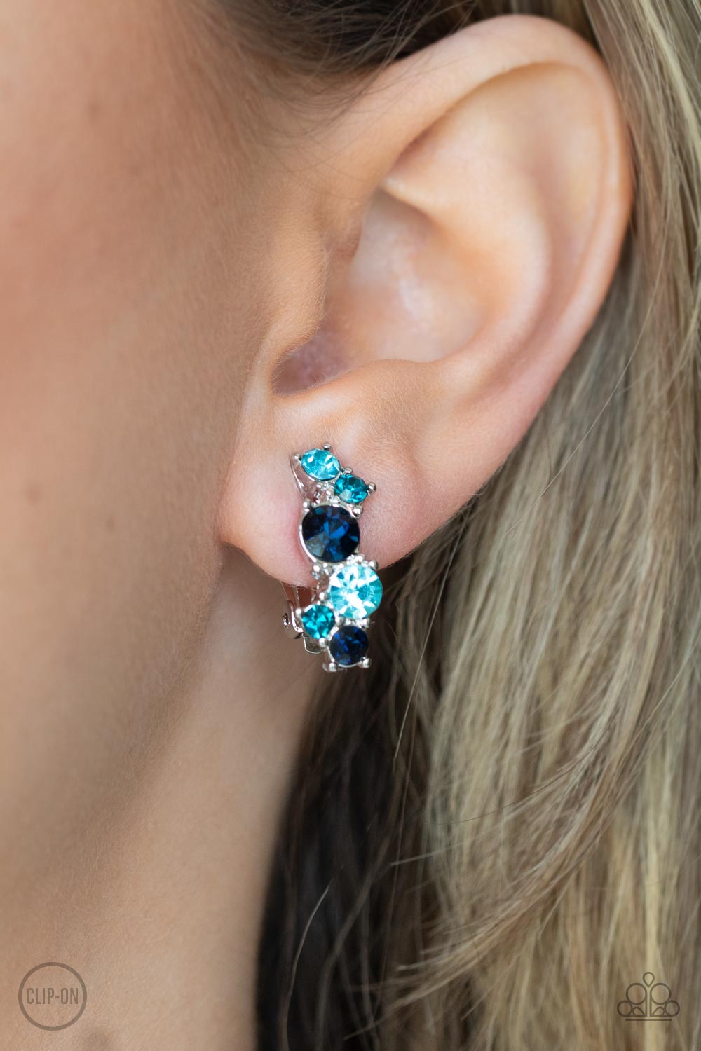 Varying in shades of blue, mismatched rhinestones delicately coalesce into a dainty frame
