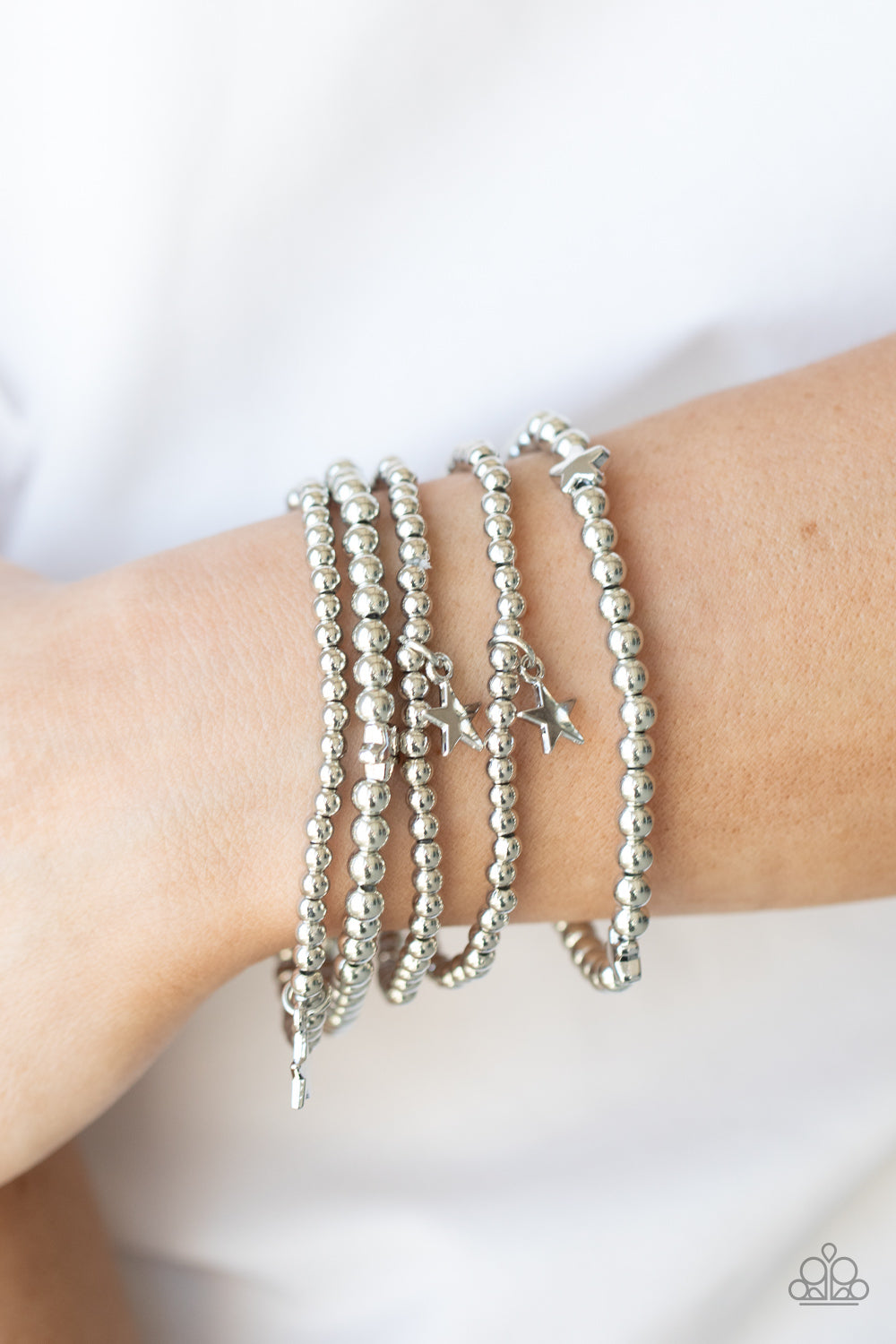 Infused with dainty silver star beads and shiny silver star charms, strands of silver beaded stretchy bands