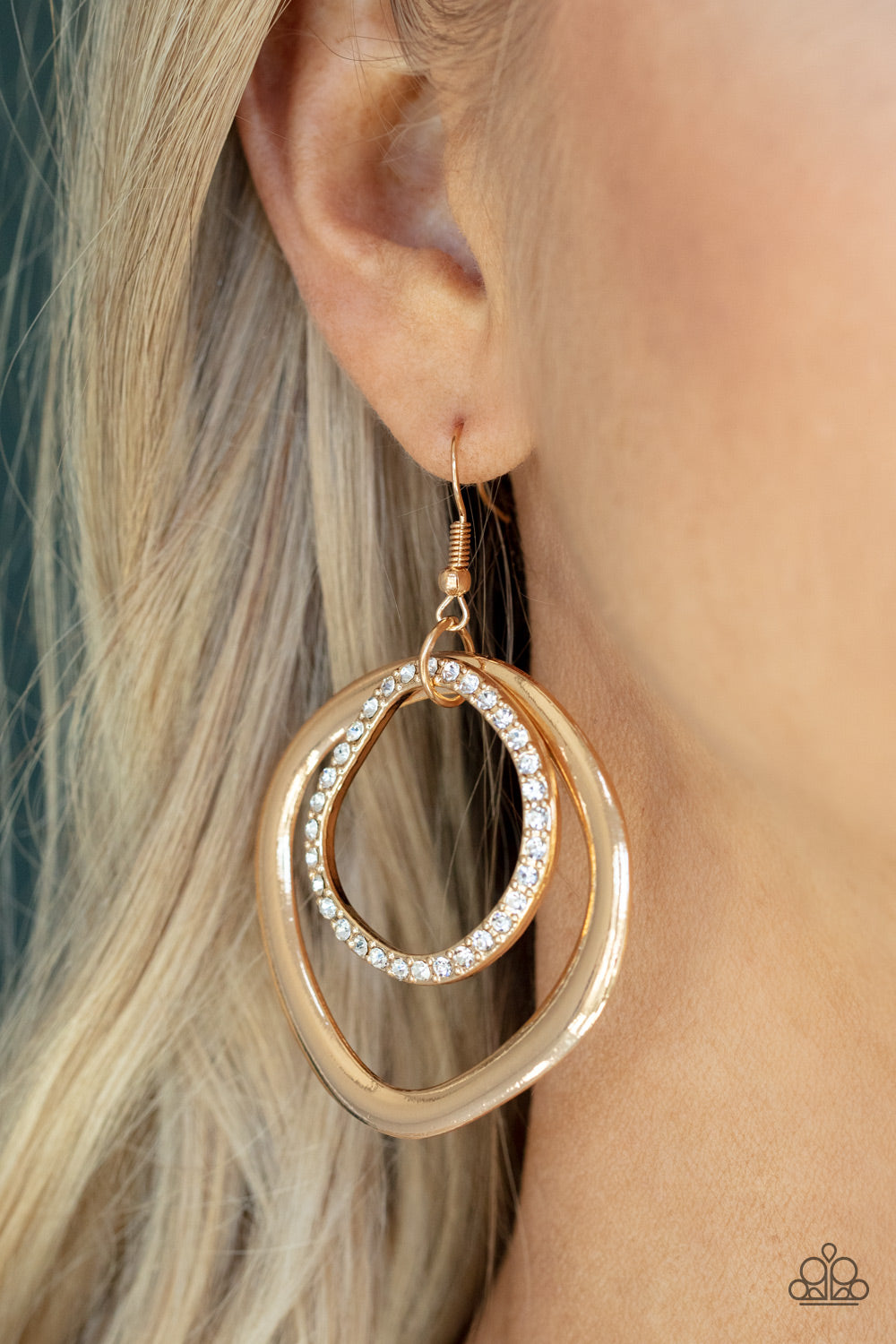 edgy asymmetrical shapes, a white rhinestone encrusted gold ring links to the top of a flattened gold ring