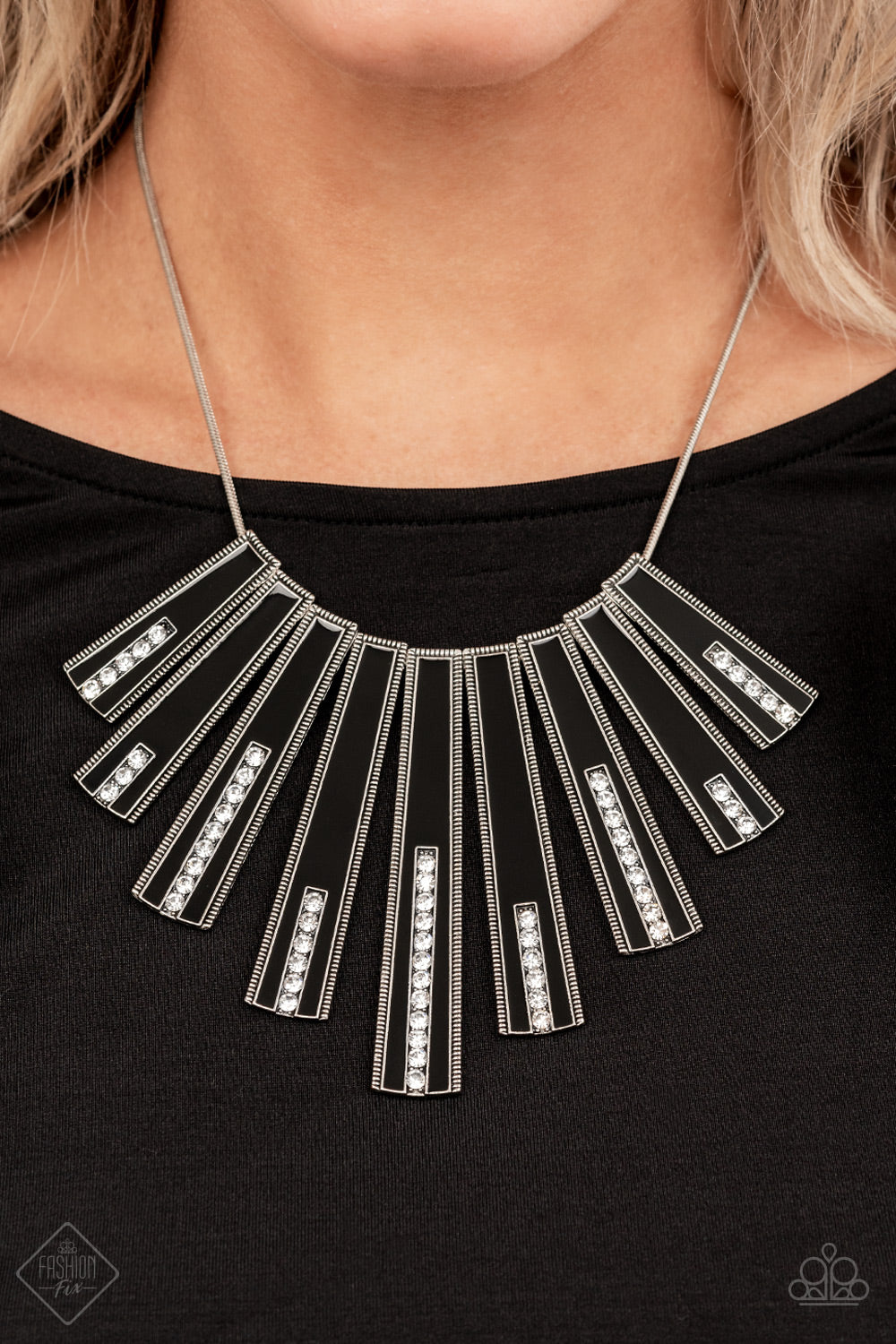 Elongated flared frames are painted in a glossy black finish and bordered by studded texture