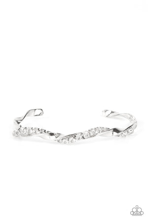 glittery strand of glassy white rhinestones twists with a shiny silver bar around the wrist, creating a dainty cuff.