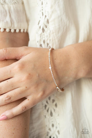 Strands of Adobe, red, white crepe-like twine wraps around circle, sphere, oval, and oblong frames that delicately connect into a decorative tassel 