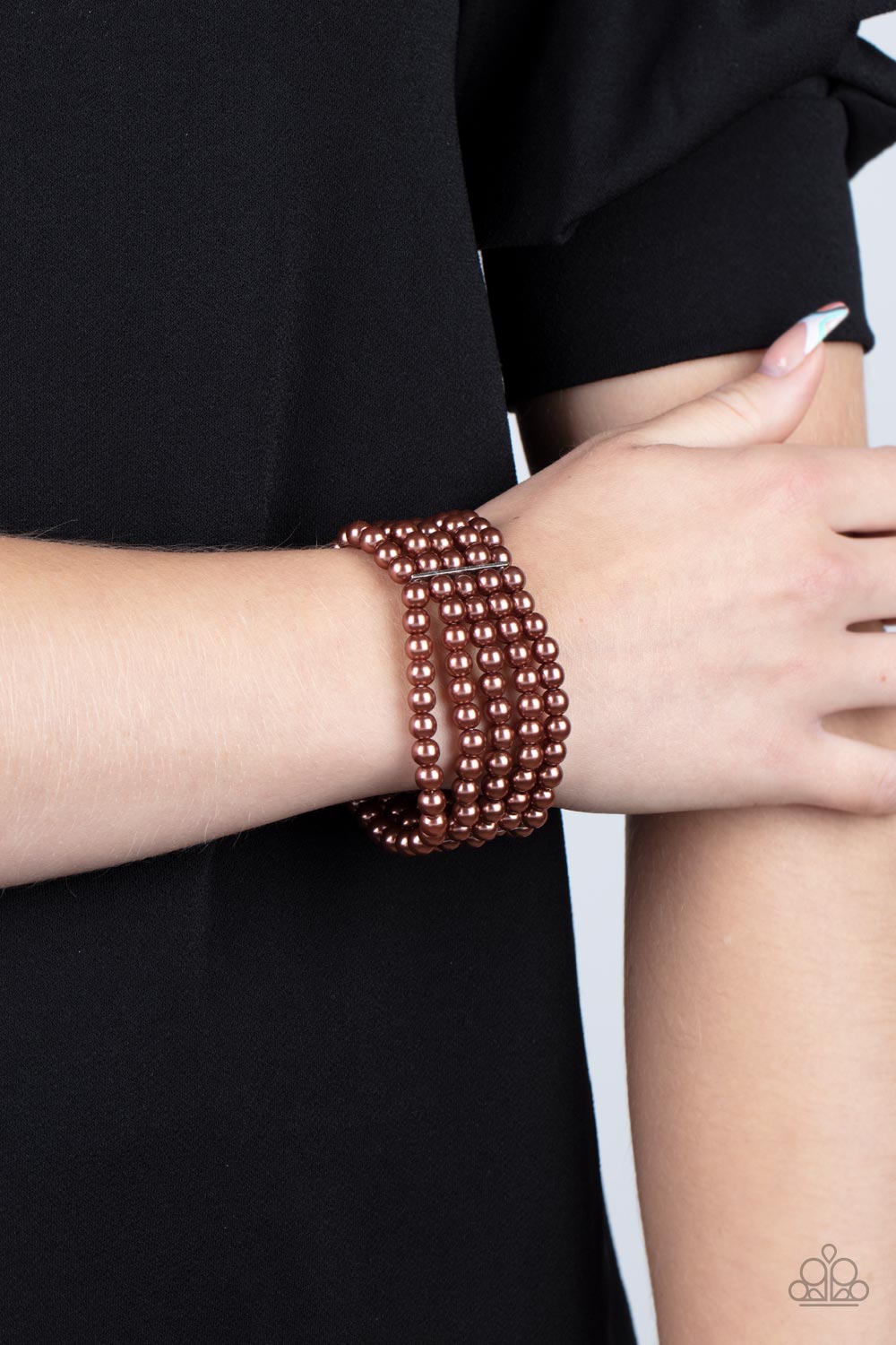 ayers of luminous brown pearl-like beads are threaded along stretchy bands