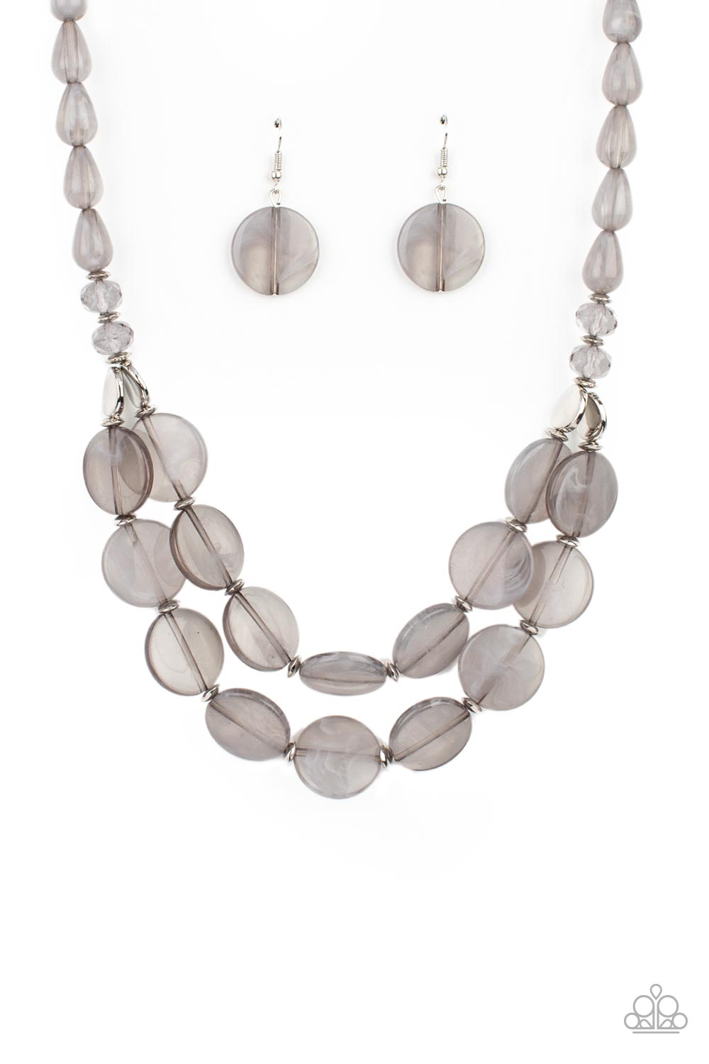 Intermixed with smoky crystal-like beads and shiny silver accents, mismatched cloudy, glassy, and opaque gray teardrop and disc beads layer below the collar 