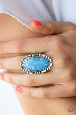 refreshing blue oval stone is pressed into the center of a textured silver frame