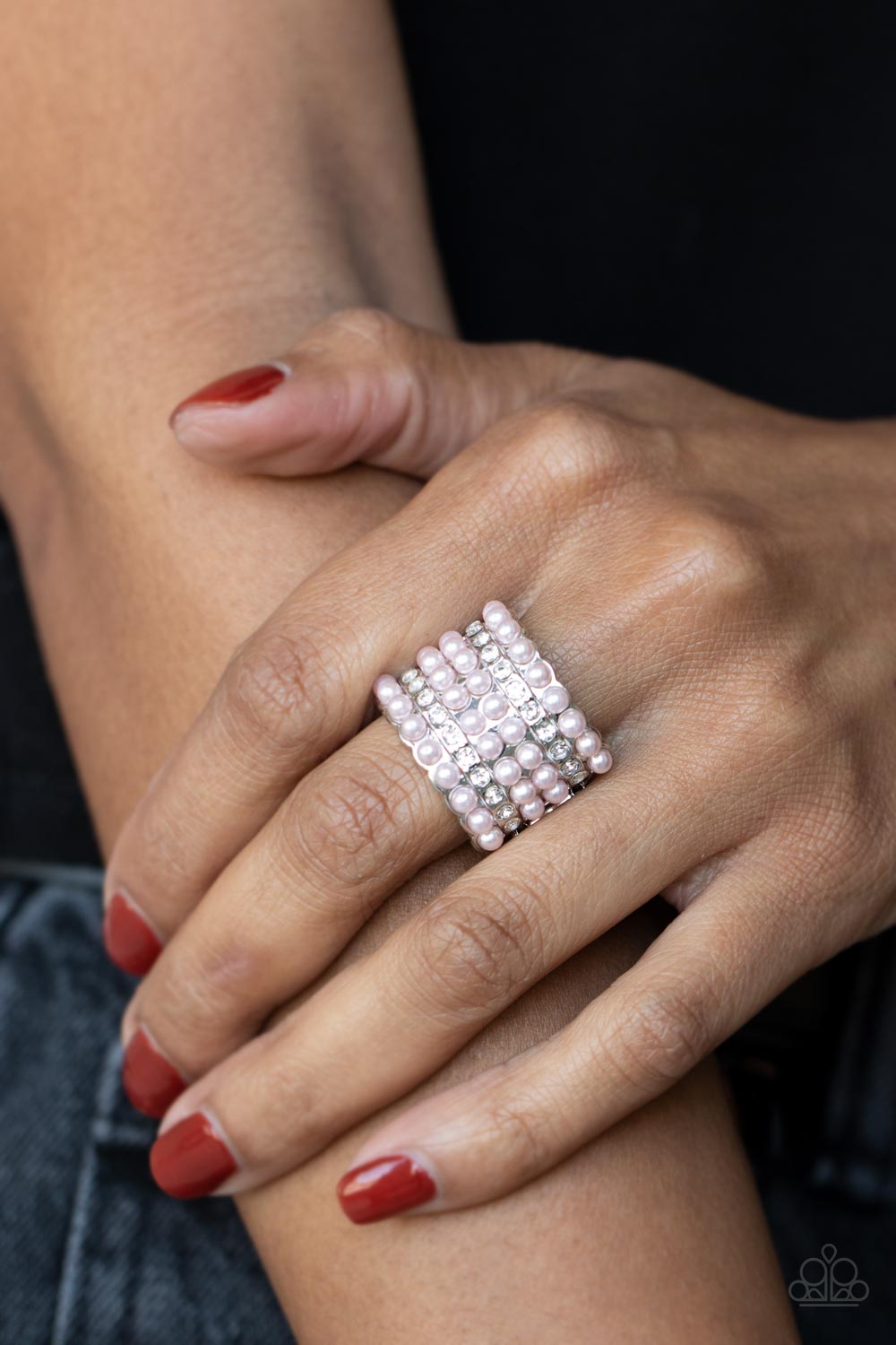 Dainty rows of bubbly pink pearls and glassy white rhinestones alternate across the front of a thick silver band