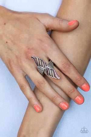  lifelike feathery detail, two airy silver wings delicately wrap around the finger. Rows of dainty purple and pink rhinestones adorn the winged accents, adding a celestial shimmer to the angelic centerpiece