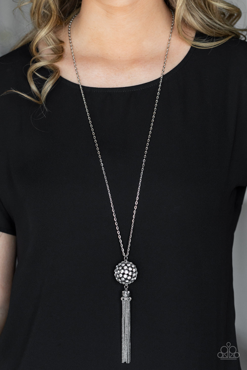 silver studded fittings, a glittery collection of sparkly white rhinestones coalesce into a dramatic pendant at the bottom of a lengthened silver chain.