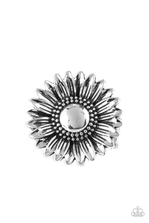 Brushed in an antiqued finish, a rustic silver daisy blooms atop a decorative studded and embossed silver band