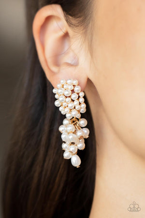 imperfect finishes, a bubbly tassel of white pearls trickles from the bottom of a pearl encrusted gold fitting
