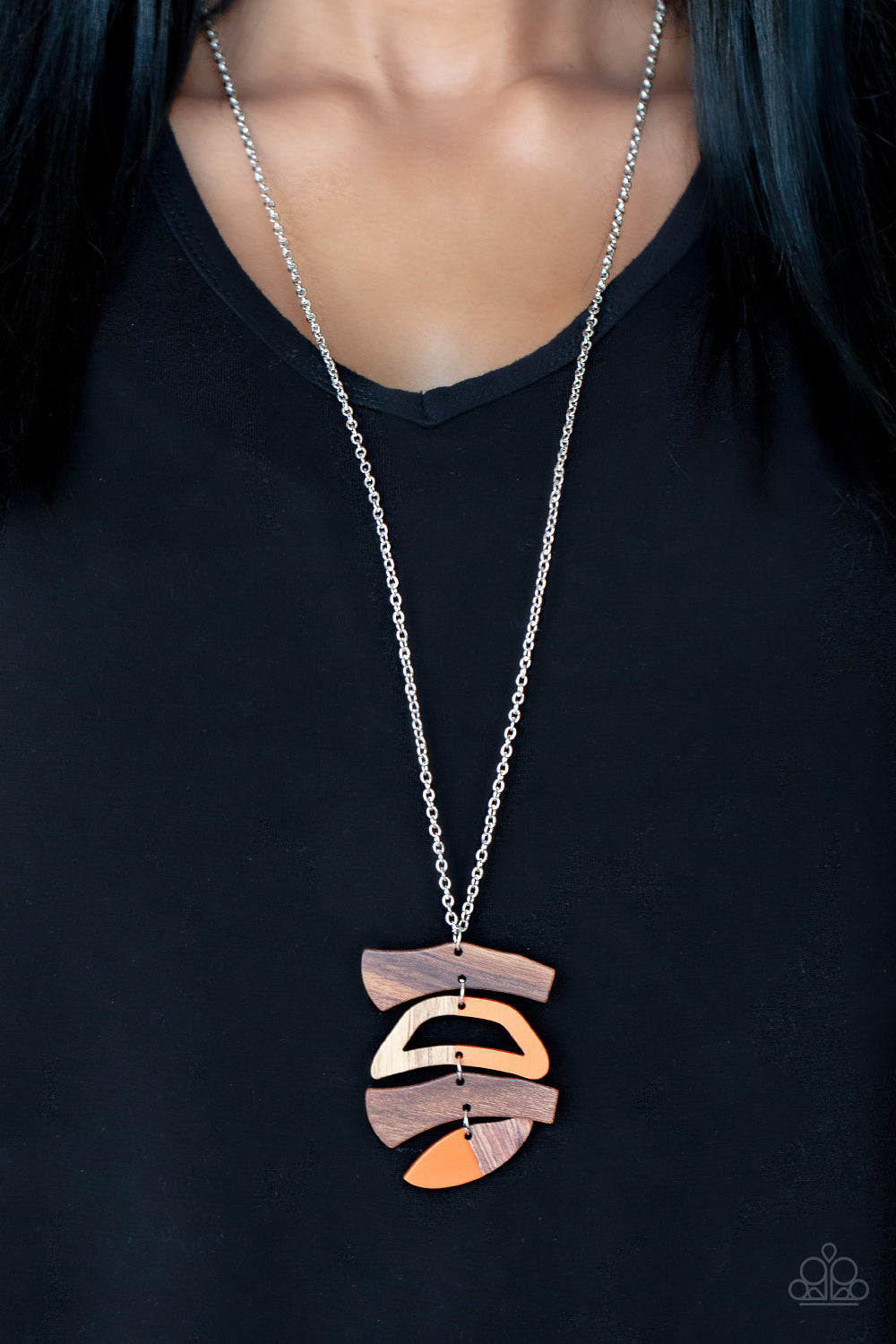 orange acrylic accents, mismatched wooden frames delicately link into an abstract pendant at the bottom of a lengthened silver chain