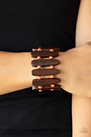 Pairs of Burnt Orange wooden beads and oblong brown wooden frames alternate along stretchy bands 