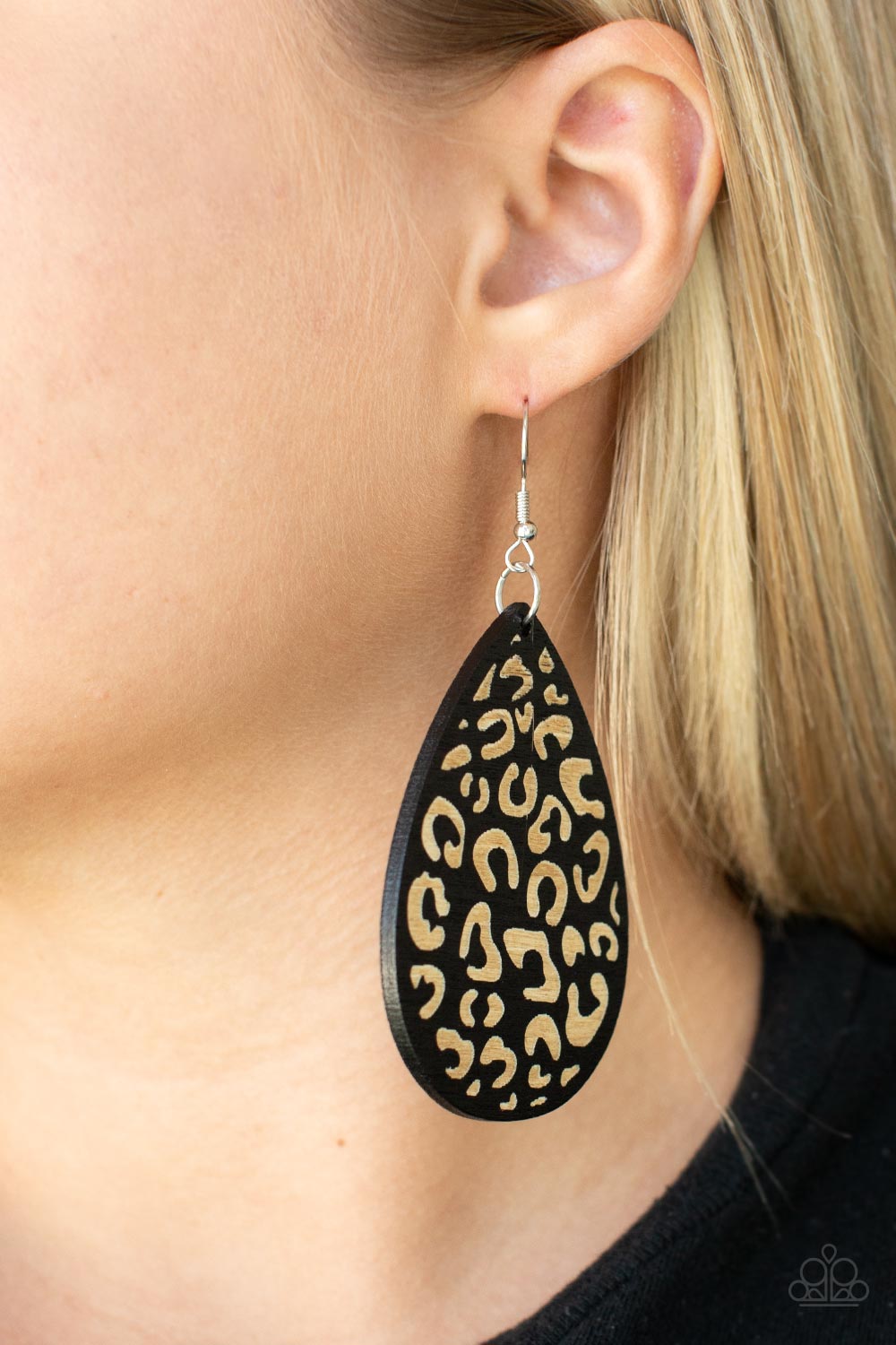 black wooden teardrop frame is etched in a cheetah-like pattern