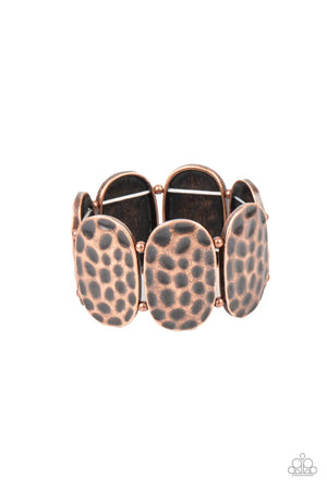 Rustically hammered copper oval frames and pairs of dainty copper beads are threaded along two stretchy bands