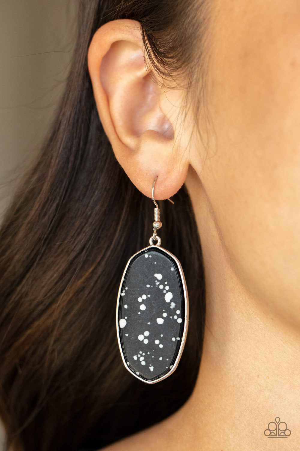 Speckled with white accents, a flat black stone is pressed into a sleek silver fitting for a colorfully seasonal look