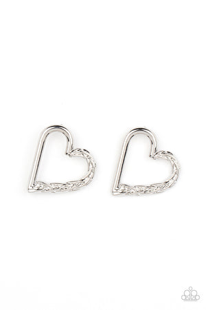 One side of a glistening silver heart frame is subtlety twisted with twinkly texture