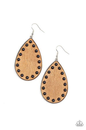 Dainty black stone beads border an earthy wooden teardrop frame that is encased in a sleek silver fitting, creating a whimsical woodsy lure. Earring attaches to a standard fishhook fitting.
