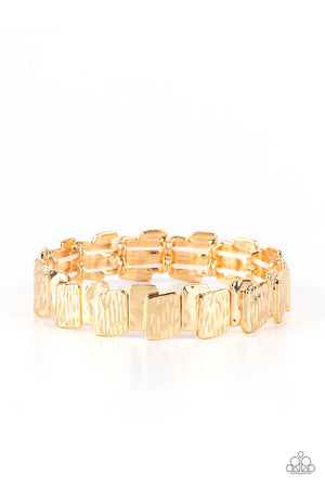 hammered and linear etched patterns, stacks of shiny gold rectangular frames are threaded along stretchy bands