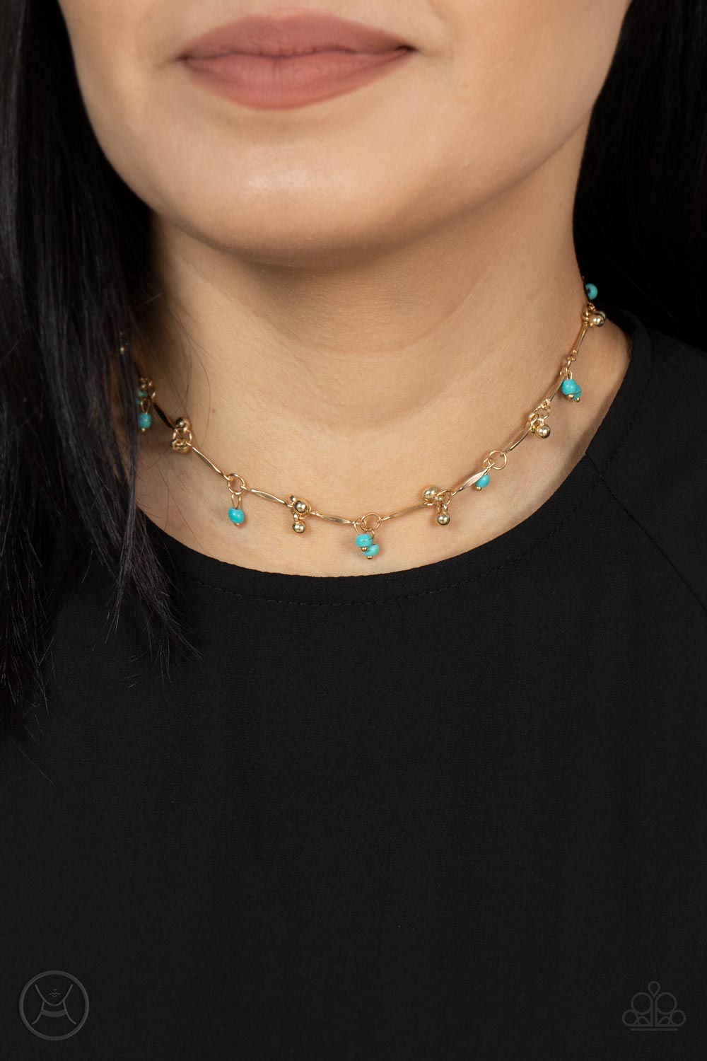 Pairs of dainty gold beads and turquoise stone beads dangle between faceted gold bars that interconnect around the neck