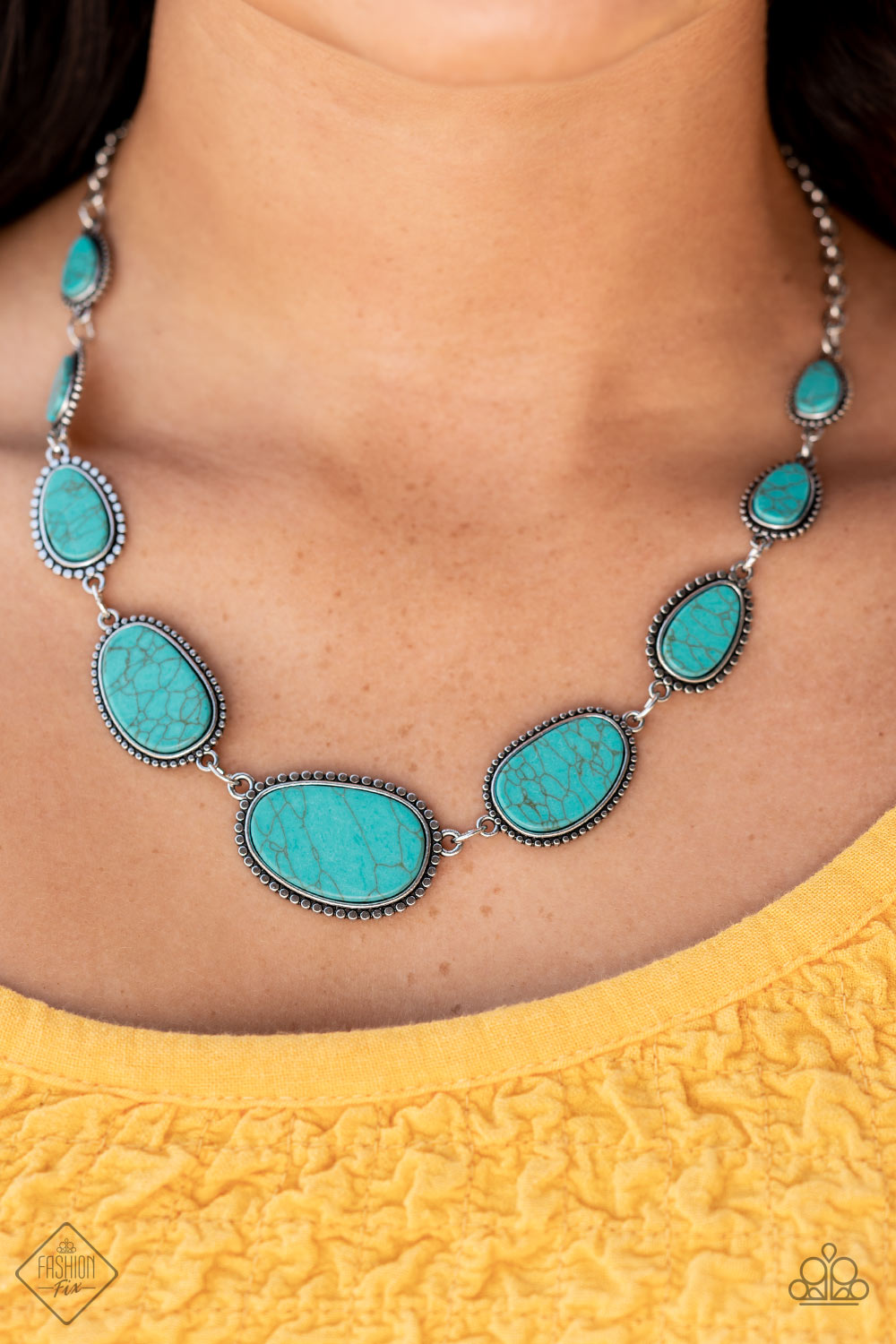 frames of flattened silver studs, pieces of flat turquoise stone teardrops and asymmetrical ovals 