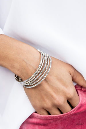 dainty infinity style bracelet is infused with glittery rows of iridescent rhinestones and curving silver frames