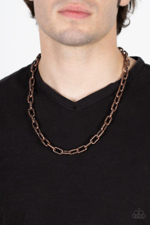Featuring gritty texture, an oversized copper chain drapes below the collar for an edgy urban look