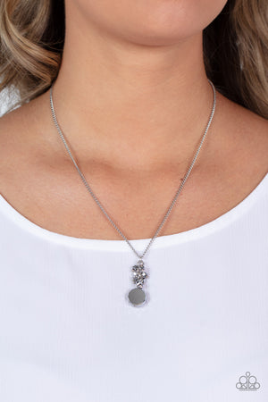 A faceted hematite gem-like bead swings from the bottom of a hematite beaded tassel, creating a twinkly pendant below the collar