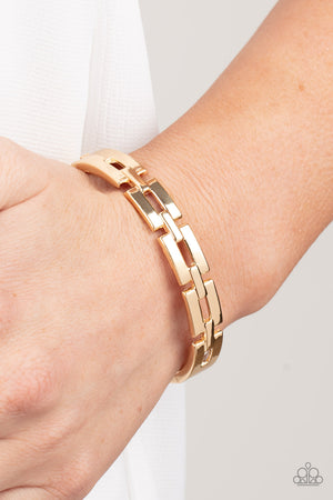rectangular gold links boldly interlock across the top of the wrist