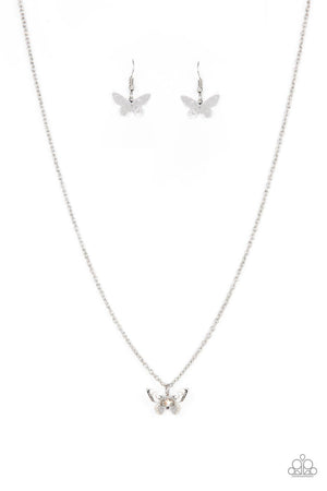 Layered with ornate silver wings, an iridescent rhinestone dotted butterfly flutters