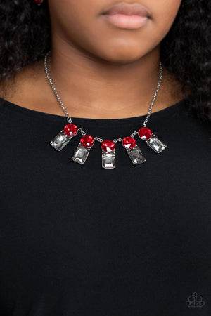 sparkly row of oversized red gems regally sit atop emerald cut smoky rhinestone bases as they delicately link along a dainty silver chain below the collar