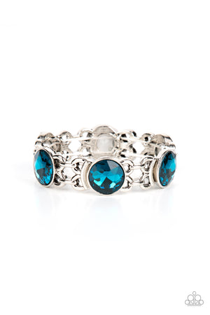 edgy chain-like fittings, a sparkly series of oversized blue rhinestones are threaded along stretchy bands