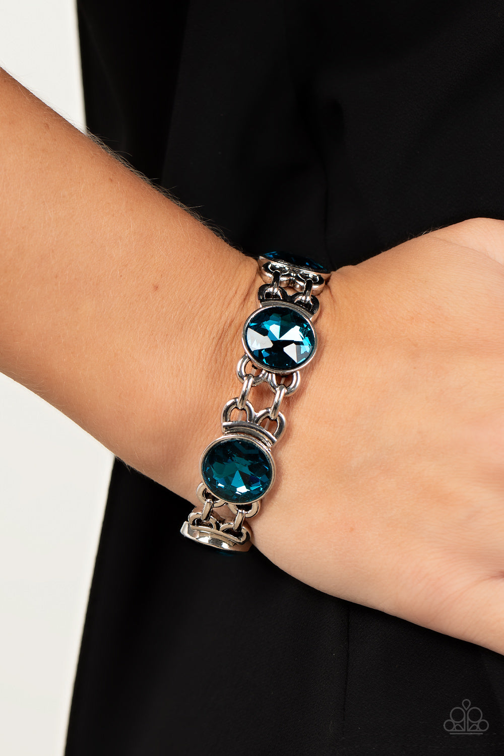 edgy chain-like fittings, a sparkly series of oversized blue rhinestones are threaded along stretchy bands