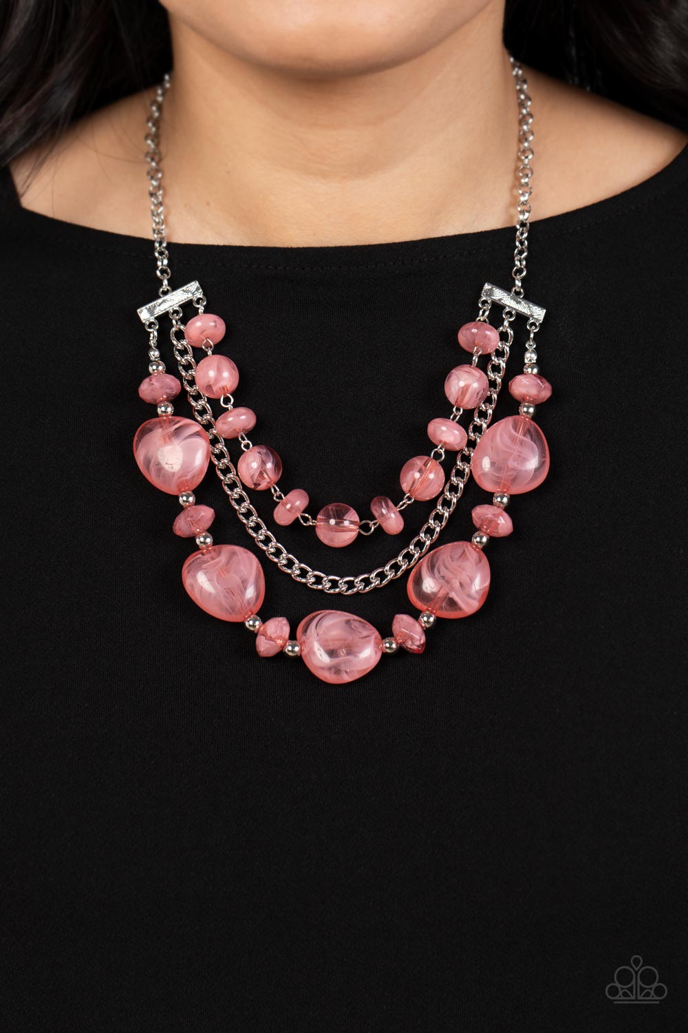  single silver chain separates two mismatched rows of oversized and cloudy glass-like pink beads