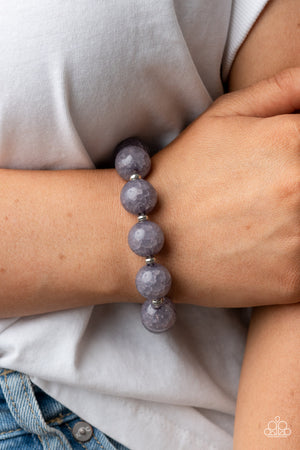 dainty silver accents, an oversized collection of crackly gray glass-like beads are threaded along stretchy bands