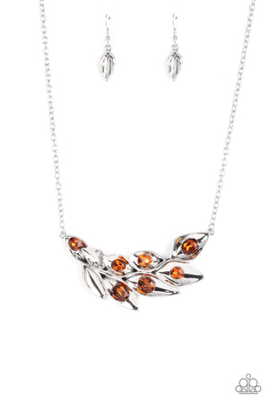 A rustic collection of leafy silver frames gently fold around their oversized topaz rhinestone centerpieces as they delicately connect into a swaying pendant