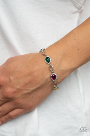 Bordered in glassy white rhinestones, glittery multicolored teardrop gems link with airy silver teardrop frames around the wrist