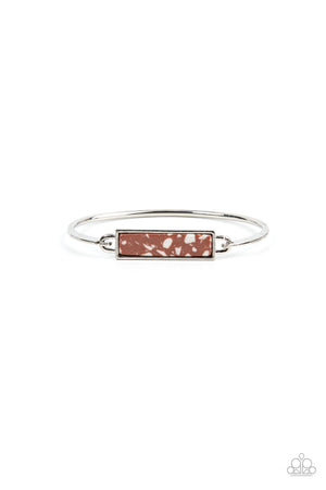 sleek silver frame, a brown terrazzo-like stone frame is fitted in place across the center of a dainty silver bangle