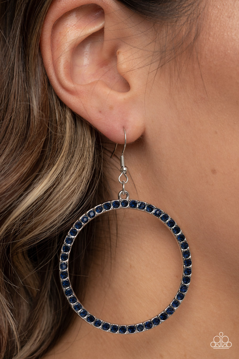 oversized silver ring is encrusted in glitzy blue rhinestones