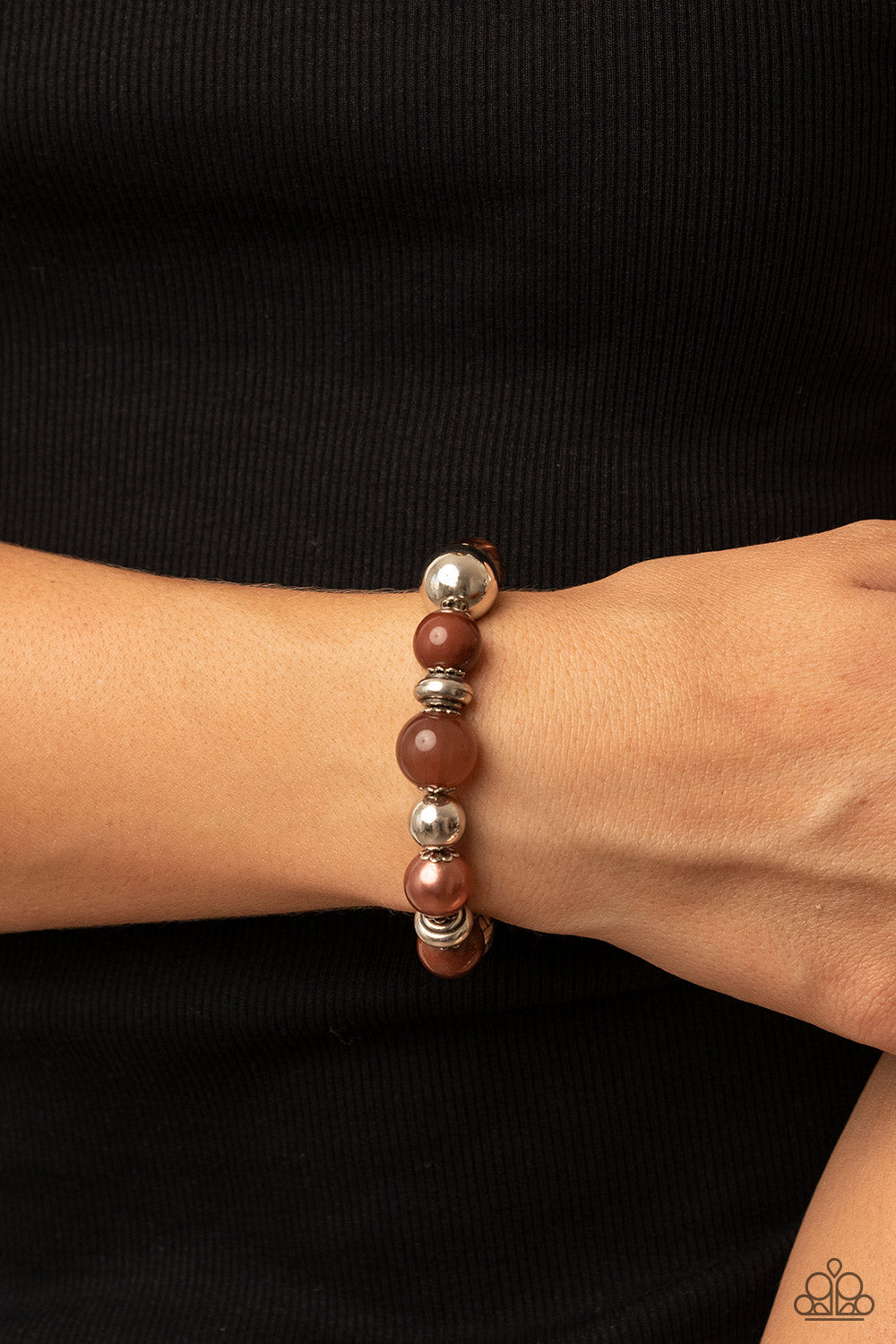 enchanting assortment of silver beads and white rhinestone encrusted silver rings join an opaque, glassy, and pearly assortment of Root Beer beads along a stretchy band 