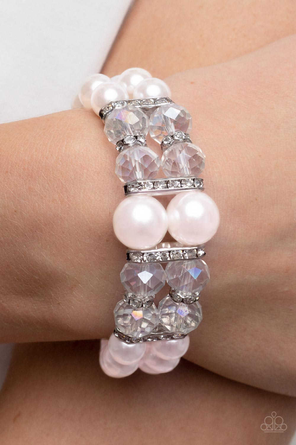 white rhinestone encrusted silver frames, a stretchy pair of bubbly pink pearl bracelets 