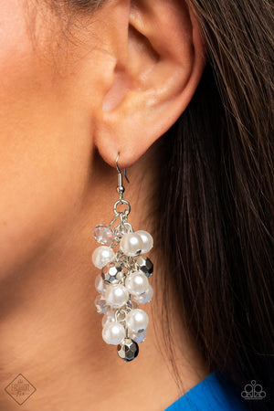 ridescent and silver beads mingle with a cluster of dreamy white pearls resulting in an elegant chandelier that sways below the ear