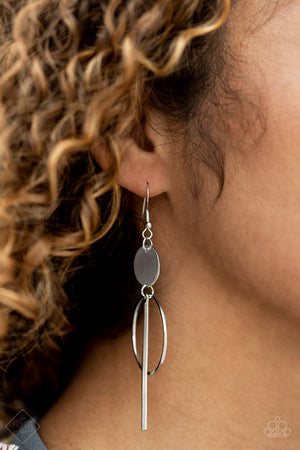 A shiny silver disc gives way to a delicate silver hoop and lengthened silver bar that sway below the ear