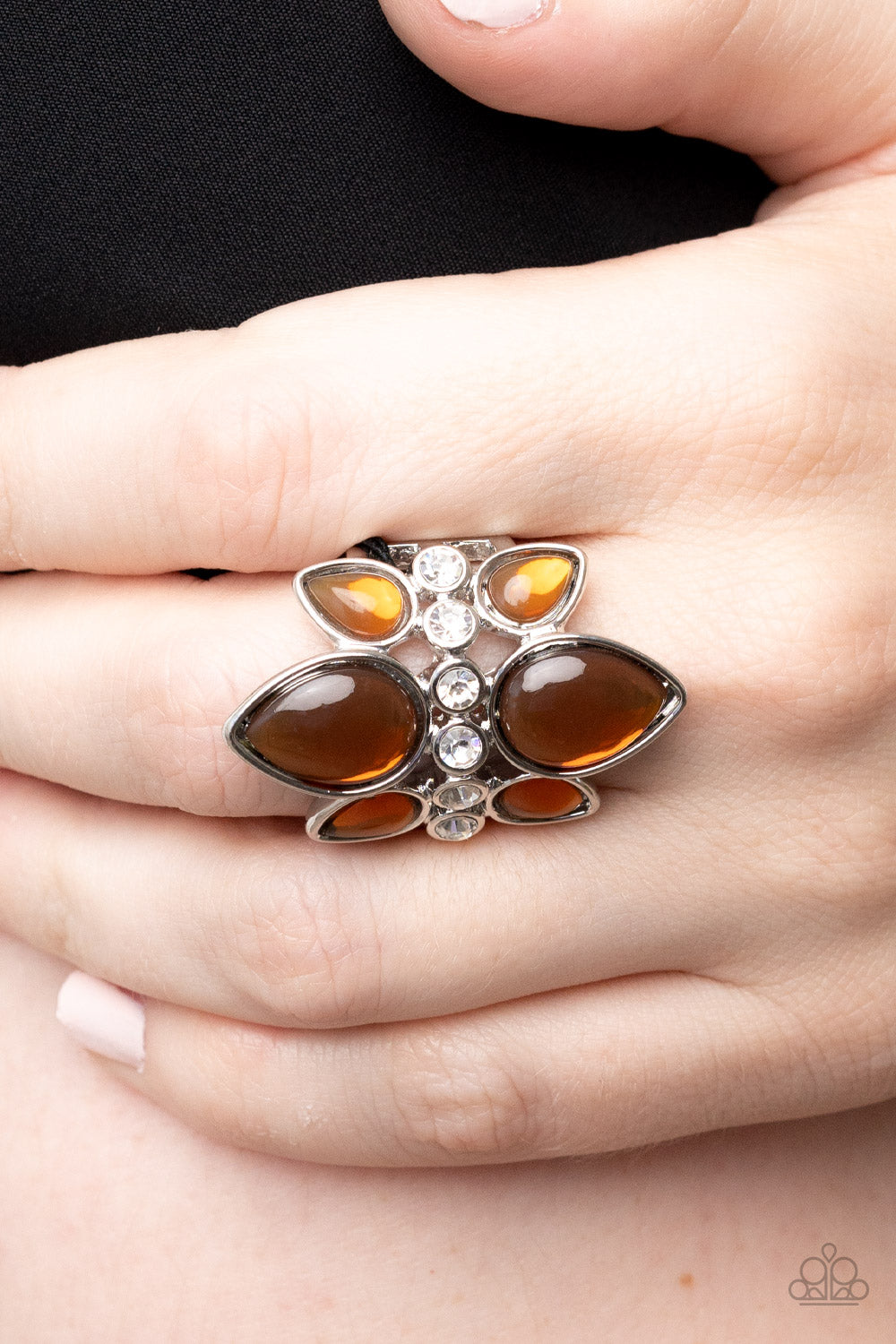 Crowns of glassy brown teardrop beads fan out from a center of glassy white rhinestones, coalescing into an ethereal centerpiece atop the finger