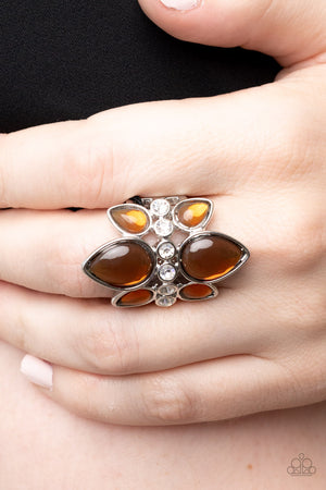 Crowns of glassy brown teardrop beads fan out from a center of glassy white rhinestones, coalescing into an ethereal centerpiece atop the finger