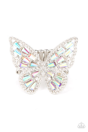 merald cut iridescent rhinestones are sprinkled across the studded wings of a shiny silver butterfly